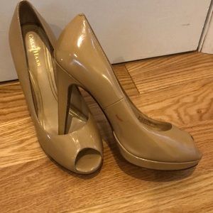Cole Haan nude patten leather peep toe heels.